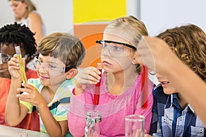 Kids doing a chemical experiment in laboratory