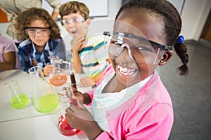 Kids doing a chemical experiment in laboratory