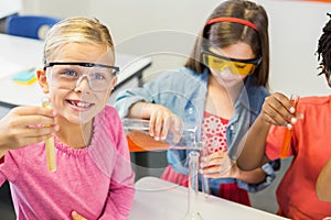 Kids doing a chemical experiment in laboratory