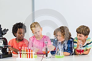 Kids doing a chemical experiment in laboratory