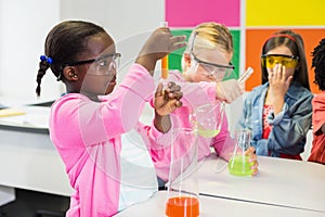 Kids doing a chemical experiment in laboratory