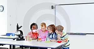 Kids doing a chemical experiment in laboratory