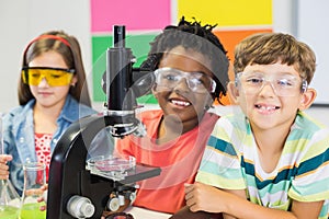 Kids doing experiment on microscope in laboratory