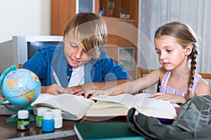 Kids doing homework with books