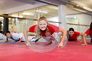 Kids doing push-ups during karate training