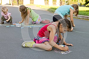 Kids drawing chalks on the pavement