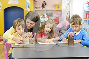 Kids and Educator Playing at Kindergarten photo