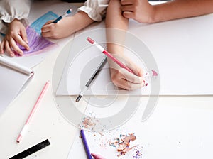 Kids are drawing picture with color pencil