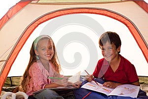 Kids drawing in a tent