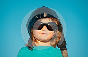 Kids dream. Caucasian child with pilot helmet and glasses, funny portrait close up. Kids face.