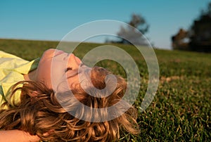 Kids dreaming. Child boy enjoying on grass field and dreaming. Kids play on summer field.