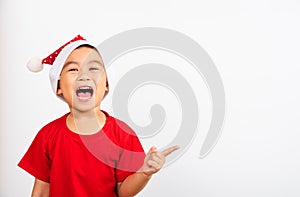 Kids dressed in red Santa Claus hat point finger