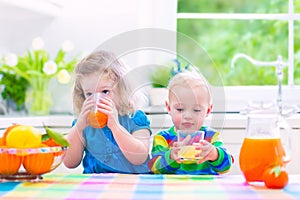 Kids drinking orange juice