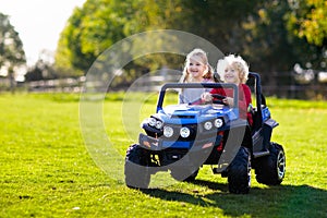 Kids driving electric toy car. Outdoor toys