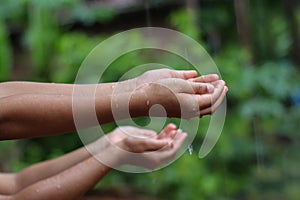 Kids Drizzling hands in rain water