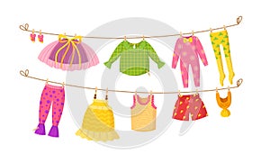 Kids dry clothes on clothesline vector cartoon illustration