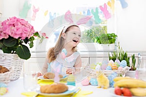 Kids at Easter breakfast. Eggs basket, bunny ears.