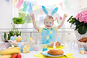 Kids at Easter breakfast. Eggs basket, bunny ears.
