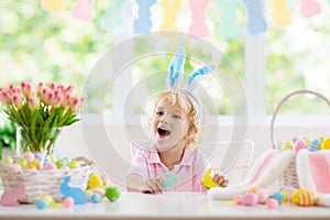 Kids on Easter egg hunt. Children dye eggs