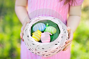 Kids on Easter egg hunt with eggs basket.