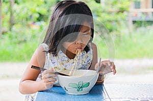 Kids eat noodles happily