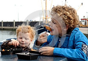 Kids eating fish