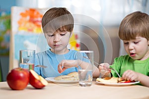 Kids eating healthy food at home