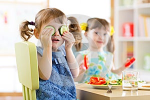 Kids eating healthy food in kindergarten or at home