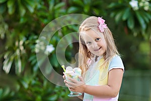 Kids eating ice cream. Child with fruit dessert.