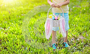 Kids with eggs basket on Easter egg hunt