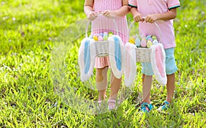 Kids with eggs basket on Easter egg hunt