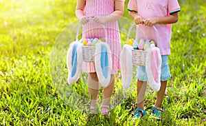 Kids with eggs basket on Easter egg hunt