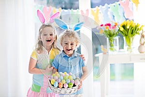 Kids with eggs basket on Easter egg hunt