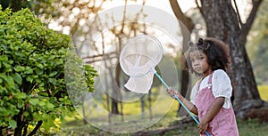 The kids enjoyed themselves as they enthusiastically pursued insects using nets in the garden.