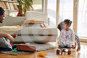 Kids enjoying playtime with their father at home. Family, together, love, playtime