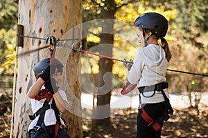 Kids enjoying zip line adventure on sunny day