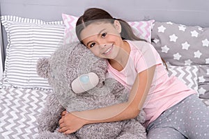 Kids evening routines. Favorite toy. Girl child hug teddy bear in her bedroom. Pleasant time in cozy bedroom. Girl kid