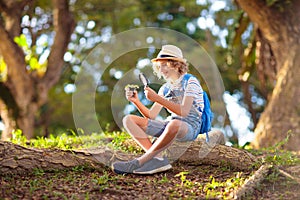 Kids explore nature. Children hike in sunny park