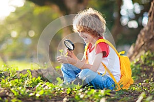 Kids explore nature. Children hike in sunny park