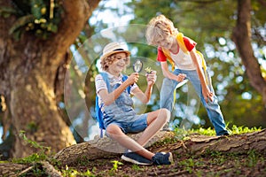 Kids explore nature. Children hike in sunny park