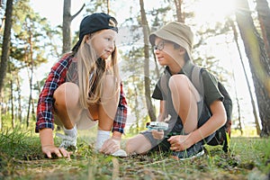 Kids exploring nature with magnifying glass. Summer activity for inquisitive child.