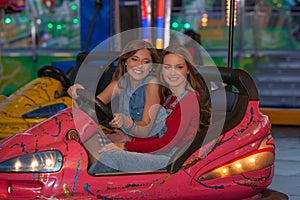 Kids at fair ground riding bumper cars