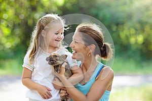 Kids and farm animals. Child with baby pig at zoo.