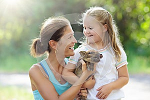 Kids and farm animals. Child with baby pig at zoo.