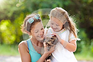 Kids and farm animals. Child with baby pig at zoo.