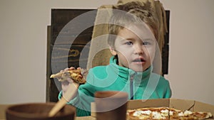 Kids Fast Food. Pizza time. Kid boy eating pizza. Junk food. Italian cuisine.