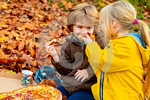 Kids favorite food. Children food concept, two happy hungry kids eating pizza.