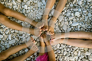 Kids feet on pebble beach