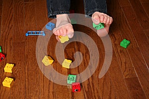 Kids feet pickup up blocks