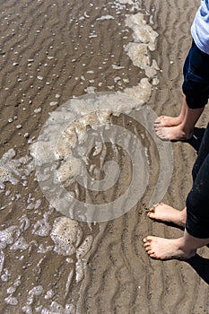 Kids feet in water on the beach